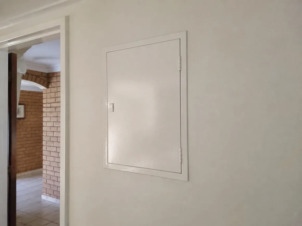 The finished switchboard closed and flush with the hallway wall
