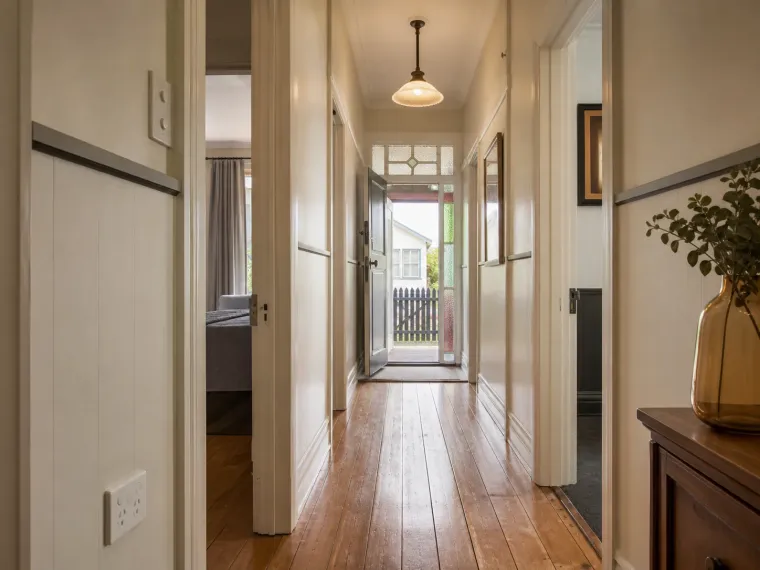 The hallway of a rewired 1920s weatherboard villa, with new outlets and light fittings in place